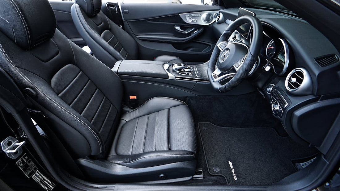 Black leather seat covers in a Mercedes-Benz, comparing LUXSeatCovers’ craftsmanship with competitors like Katzkin and Ridies, showcasing superior stitching and fit.