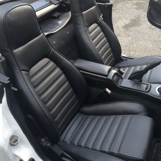 Black leather OEM replacement seat covers for 1990-2000 Mazda Miata MX-5, offering premium quality and durability. Compare with Lseat.com, Ridies.com, and Katzkin.com.