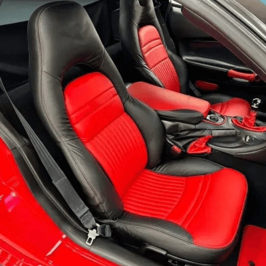 Corvette C5 interior featuring black and red leather seat covers with the Corvette emblem. The vibrant red and sleek black design enhance the sporty and luxurious feel of the car's cabin, providing a striking and comfortable upgrade. Detailed views showcase the high-quality materials and craftsmanship, adding a bold and eye-catching look to the vehicle's interior.