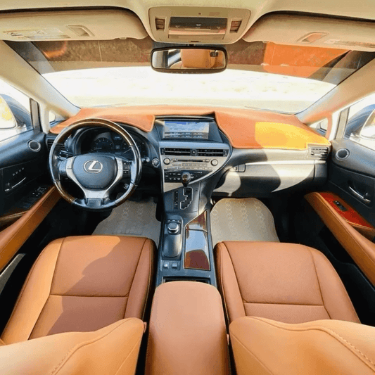 Full dashboard and interior view of a Lexus RX350/RX450h featuring brown leather seat covers complementing the vehicle's elegant design