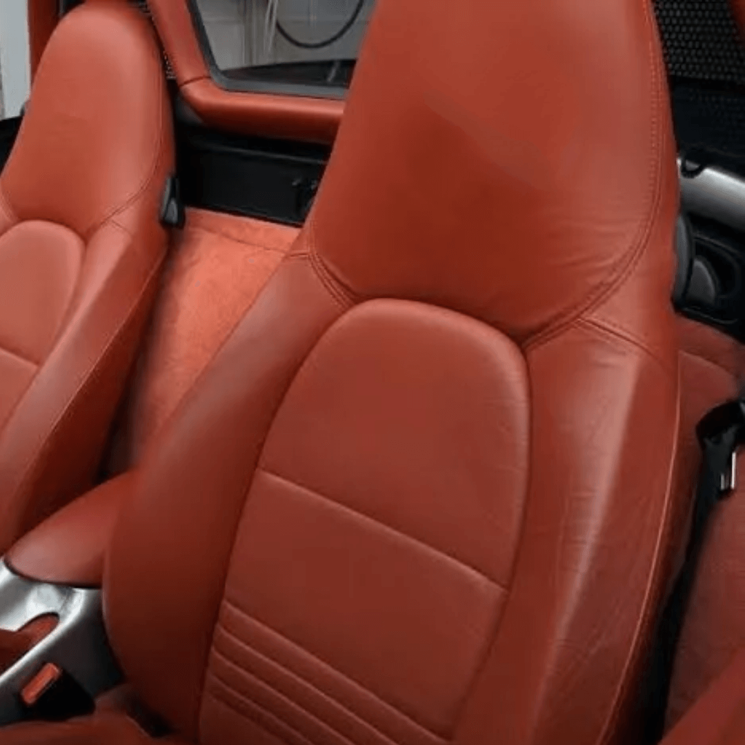 Detailed view of Porsche Boxster 986 (1997-2004) red leather seat covers, highlighting premium quality and luxurious interior upgrade.